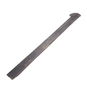 May include: A vintage metal chisel with a rectangular blade and a curved end. The chisel has the text "ALEX. MATHIESON & SON GLASGOW" stamped on the blade. The tool is a dark gray color and appears to be well-used.