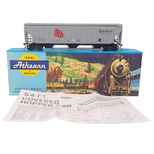 May include: A gray Athearn model train car with red logo and the text "Carlon" on top of a box with a train illustration. The box reads "Athearn in Miniature" and "54 FT. COVERED HOPPER CAR".