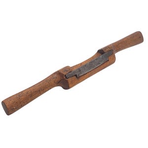 May include: A vintage drawknife with a wooden handle and a steel blade. The tool is designed for shaping wood and has a rustic, well-worn appearance. The drawknife is a woodworking tool.