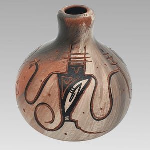 May include: A handcrafted ceramic vase with a rounded body and a narrow neck. The vase features a design with brown and black tribal-inspired figures and patterns against a beige and reddish-brown background. The vase is a decorative item.