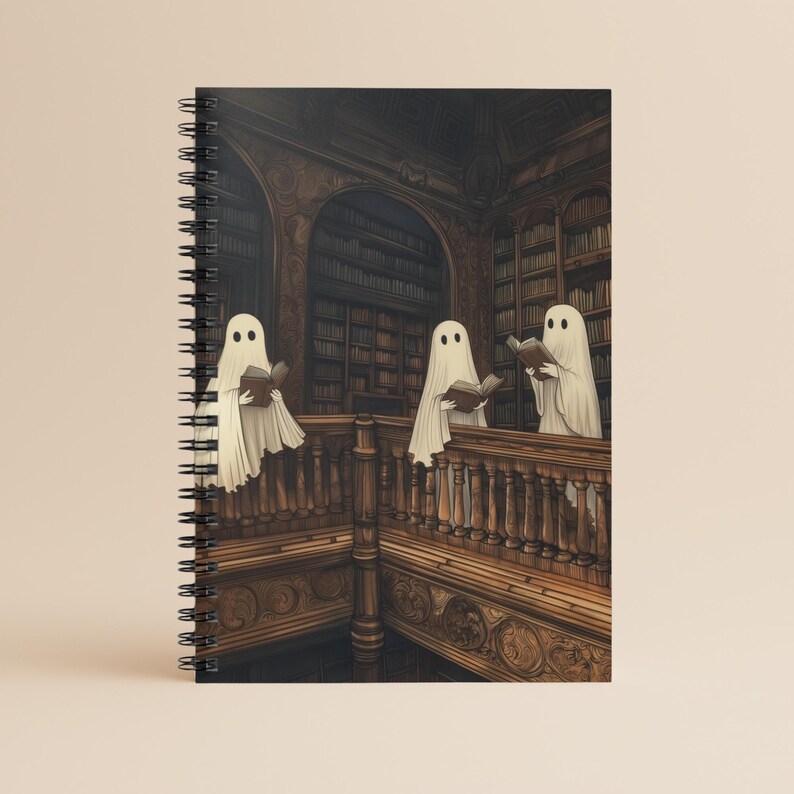 Spiral-bound notebook featuring three ghosts reading books in a haunted vintage library with carved wooden shelves. Perfect for ghost lovers, gothic aesthetic fans, and book lovers who enjoy spooky Halloween themes.