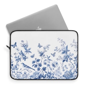 May include: A blue and white laptop sleeve with a floral pattern. The design features delicate blue flowers, leaves, and butterflies on a white background.