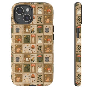 May include: A phone case with a pattern of cats, mushrooms, and leaves on a brown background. The case is black and has a raised camera bump.