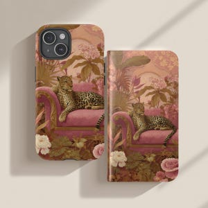 May include: A phone case and wallet case featuring a leopard lounging on a pink sofa. The cases have a floral and botanical background with a vintage aesthetic. The leopard has a spotted coat.