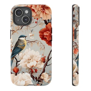 May include: A phone case with a floral design featuring a blue bird, white and red flowers, and a gray background.