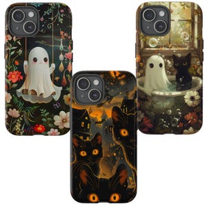 May include: Three phone cases with Halloween-themed designs. One case features a ghost on a swing surrounded by flowers. Another shows black cats with glowing eyes against a haunted house backdrop. The third case depicts a ghost and a black cat in a bathtub.