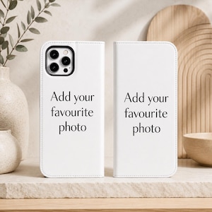 Pode incluir: Uma capa de telemóvel tipo carteira branca com um recorte preto para a câmara e o texto impresso a preto Add your favourite photo nos painéis frontal e traseiro. A capa foi concebida para um smartphone e apresenta uma superfície personalizável.