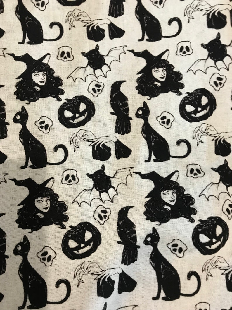 May include: Black and white fabric with a repeating pattern of witches, cats, bats, pumpkins, ravens, and skulls. The fabric has a vintage aesthetic.