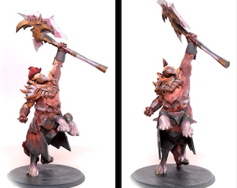 May include: A red and gold painted miniature figurine of a warrior riding a beast, holding a large axe above its head. The figurine is posed in a dynamic action pose, with the warrior's legs raised and the beast's head tilted back. The figurine is set on a black circular base.
