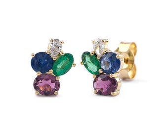 May include: Gold earrings with a cluster of colorful gemstones, including emerald green, sapphire blue, and amethyst purple stones.