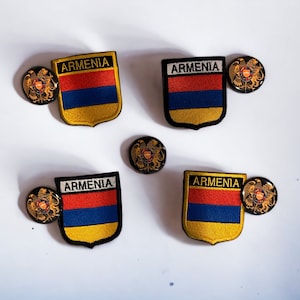 May include: Four embroidered patches with the Armenian flag and the words "Armenia" in gold lettering. Each patch is surrounded by a black border and has a gold eagle emblem.