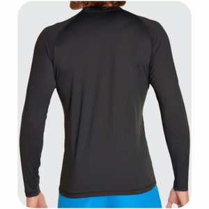May include: Black long-sleeve rash guard shirt with a crew neck.
