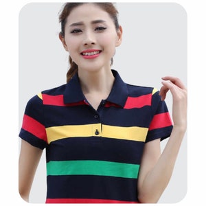 May include: A striped short-sleeved polo shirt with red, yellow, green, and blue stripes. The shirt has a button-down collar and a button placket.