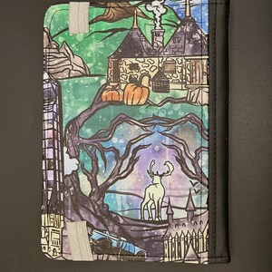 May include: A colourful illustrated fabric featuring a scene from the Harry Potter universe. The fabric depicts a cottage with a chimney, a stag, a car, and a castle. The fabric is perfect for crafting projects like tote bags, cushions, and more.