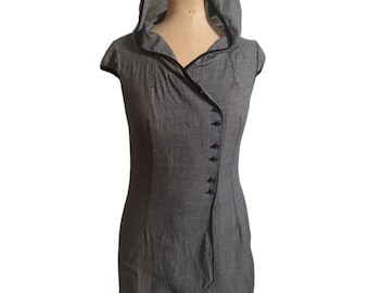 May include: A gray hooded sleeveless top with a button closure down the front. The top has a slightly asymmetrical hemline.