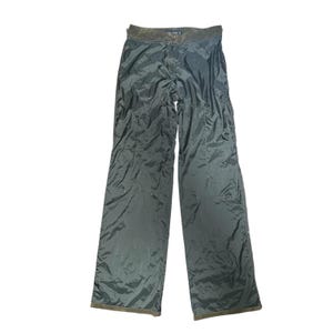 May include: Olive green trousers with a wide leg cut. The trousers feature a dark brown waistband and a button and zip fastening. The fabric has a subtle sheen, and the trousers appear to be made of a lightweight material.