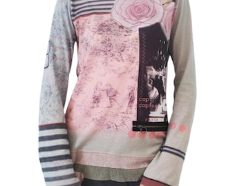 May include: A long-sleeved shirt with a gray and pink background. The shirt features a large pink rose, a black and white photo of people, and the text "cop cop copine" and "Paolo".