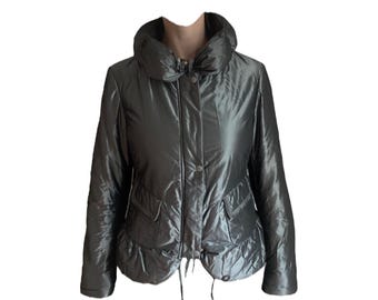 May include: A dark gray puffer jacket with a high collar and two front pockets. The jacket has a shiny, metallic finish and a drawstring at the waist. It features a button closure and a quilted design.