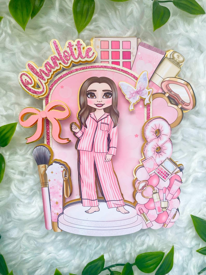 Personalized makeup-themed cake topper featuring a girl in pink striped pajamas surrounded by beauty and spa accessories including makeup brushes, lipstick, blusher, eyeshadow, skincare items, and a pink bow. The topper is decorated in pink glitter card and gold mirror  with the name and age of the birthday girl, making it perfect for a glam birthday, spa party, or makeup-themed celebration.