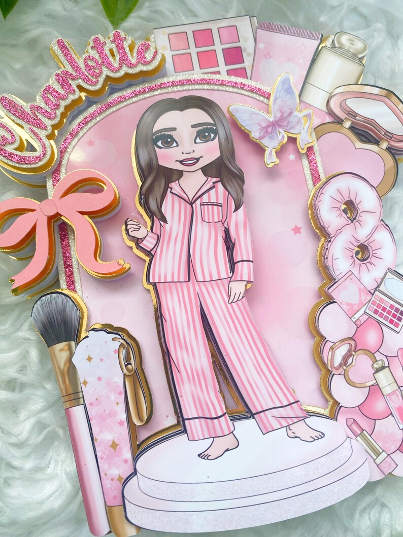 Personalized makeup-themed cake topper featuring a girl in pink striped pajamas surrounded by beauty and spa accessories including makeup brushes, lipstick, blusher, eyeshadow, skincare items, and a pink bow. The topper is decorated in pink glitter card and gold mirror  with the name and age of the birthday girl, making it perfect for a glam birthday, spa party, or makeup-themed celebration.