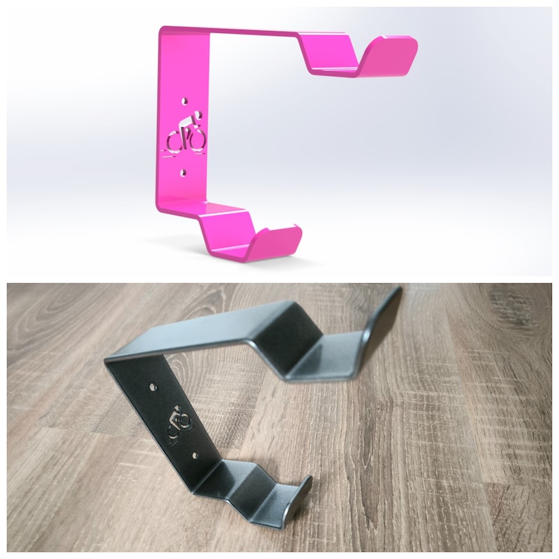 May include: Two bike hooks, one pink and one black, with a bicycle silhouette design. The hooks are made of metal and are designed to be mounted on a wall.