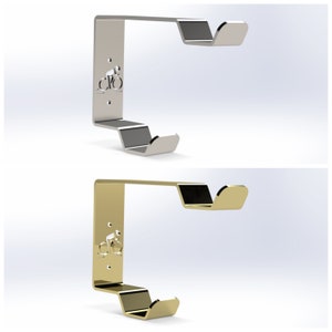 May include: Two bike hooks, one silver and one gold, with a bicycle silhouette design. The hooks are designed to hang bikes on a wall.