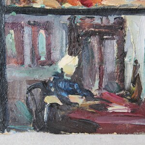 May include: A painting of a room interior with a black frame. The room is painted in shades of gray, blue, and red. There are two windows in the back wall, and a large piece of furniture in the foreground.