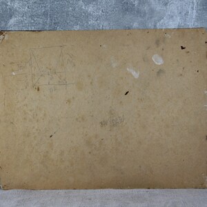 May include: The back of a brown cardboard picture frame with some faint pencil markings and a few white smudges.