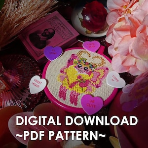 May include: A pink and white cross-stitch pattern featuring a cartoon character with a crown and wings. The pattern is surrounded by pink and white heart-shaped candies with Valentine's Day messages. The text "DIGITAL DOWNLOAD ~PDF PATTERN~" is at the bottom of the image.