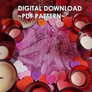 May include: A digital download PDF pattern for a cross-stitch design featuring a spider web with a spider in the center. The design is surrounded by red and pink hearts with various messages, including "Love Bug", "Be Mine", "Love U", and "UR Cute".