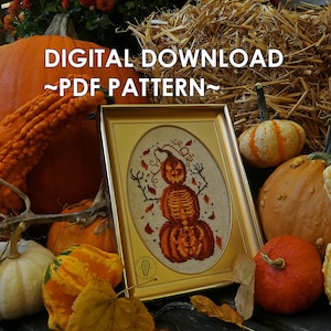 May include: A digital download PDF pattern for a cross stitch design featuring a spooky pumpkin with a skeleton inside. The pattern is framed and surrounded by various pumpkins and gourds.