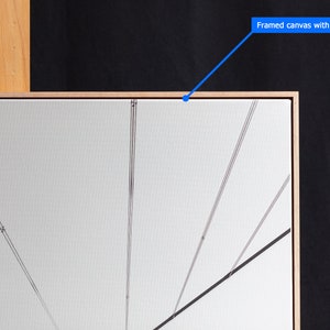 May include: A framed canvas with a 1/8 inch gap between the canvas and the frame. The canvas is white and has black lines drawn on it.
