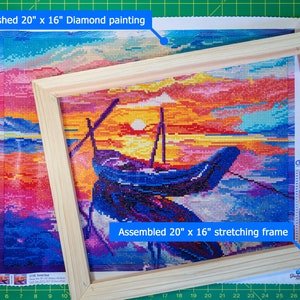 May include: A finished 20" x 16" diamond painting of a sunset seascape with a boat in the foreground. The painting is mounted in a wooden stretching frame.