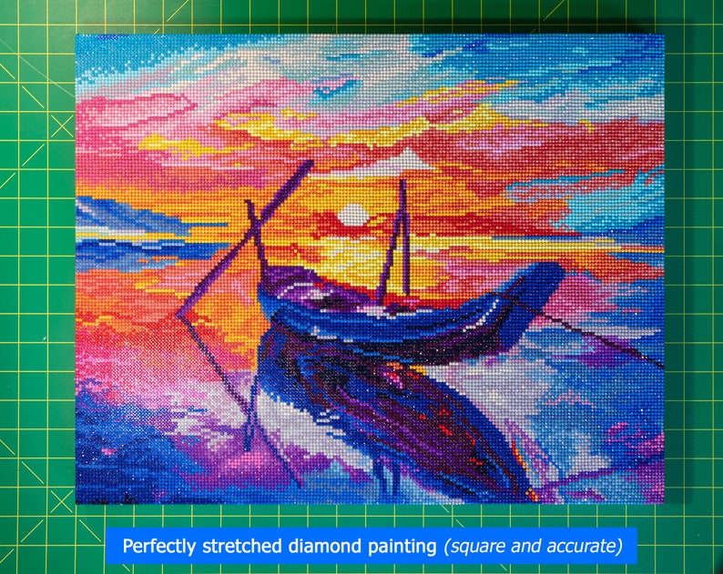 May include: A diamond painting of a boat sailing on the water at sunset. The sky is a vibrant mix of pink, orange, and yellow, with a bright sun shining in the distance. The boat is a dark blue color and is partially submerged in the water. The water is a mix of blue and purple, with white waves crashing against the shore.