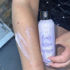 May include: A purple bottle of body lotion with the text "Body lotion Jamaican Me Crazy" on the label.