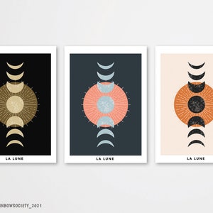 May include: Three minimalist art prints with a moon phase design. Each print features a different color background: black, blue, and beige. The moon phases are depicted in black and white, with a large circle in the center of each print.
