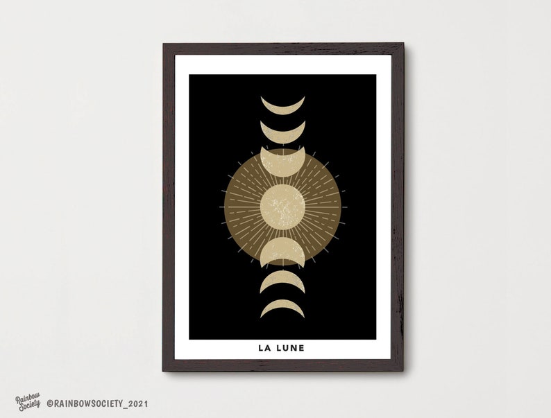 May include: A black and gold minimalist print with a stylized moon and sun design. The text "LA LUNE" is at the bottom of the print.