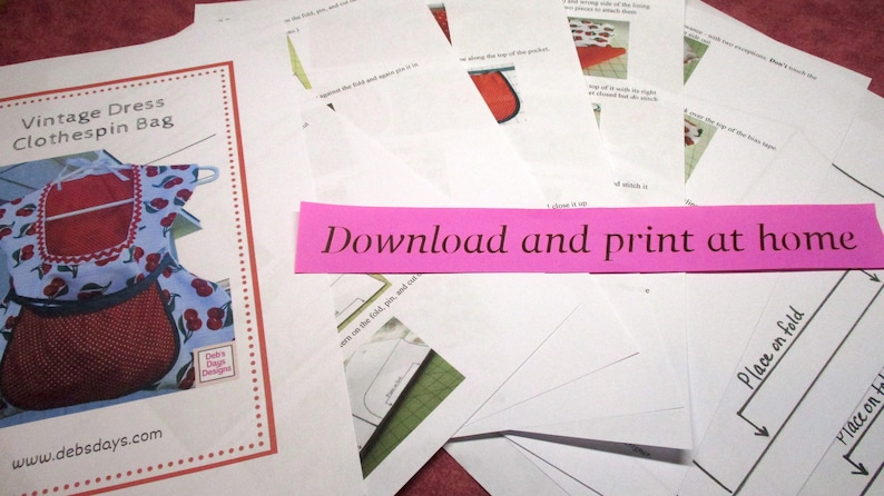 May include: A printable pattern for a vintage-style dress clothespin bag. The bag is red and white with a cherry print. The pattern includes instructions to download and print at home.