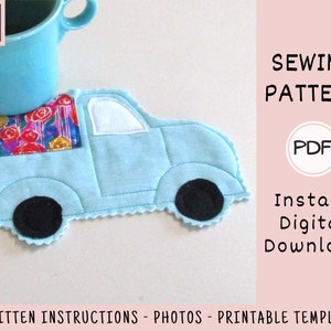 May include: A PDF sewing pattern for a blue truck-shaped coaster with black wheels and a floral print in the bed. The pattern includes written instructions, photos, and a printable template.  The text "SEWING PATTERN" and "PDF" are visible in the image.