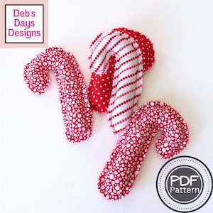 Puede incluir: Tres bastones de caramelo de tela hechos a mano con patrones rojos y blancos. Uno presenta lunares rojos sobre blanco, otro tiene rayas rojas y blancas, y el tercero tiene lunares blancos sobre rojo. La imagen incluye el texto "Deb's Days Designs" y "PDF Pattern".