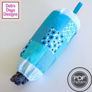 May include: A blue and white patchwork fabric bag for storing plastic grocery bags. The bag has a drawstring closure and a loop handle. The bag is labeled "PDF Pattern".