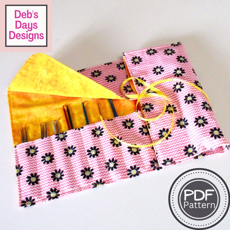 May include: A pink and black fabric needle roll with a yellow daisy print. The roll is open and has several knitting needles inside. The roll is tied with a yellow ribbon. The text "PDF Pattern" is visible in a circle on the bottom right of the image.
