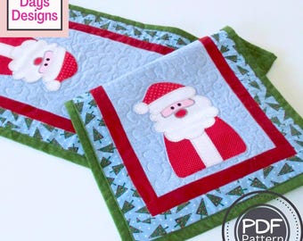 May include: A quilted table runner with a Santa Claus design. The runner is blue with a green and red border. The border is decorated with small Christmas trees. The text "PDF Pattern" is visible in the lower right corner of the image.