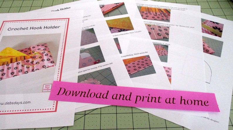 May include: A set of instructions for making a crochet hook holder. The instructions are printed on white paper and include photos of the finished product. The instructions are titled "Crochet Hook Holder" and include the text "Download and print at home".