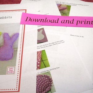May include: A printable pattern for making fabric rabbits. The pattern includes instructions for sewing the fabric pieces together and a template for the rabbit's ears. The text on the page reads "Fabric Rabbits" and "Download and print at home".