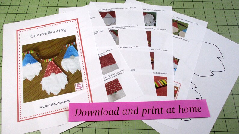 May include: A set of printable instructions for making a gnome bunting. The instructions include a pattern for the gnome's hat, beard, and body. The instructions also include a pattern for a tree. The instructions are titled "Gnome Bunting" and include the website "www.debsdays.com". The instructions are printed on white paper and have a pink strip at the bottom that says "Download and print at home".