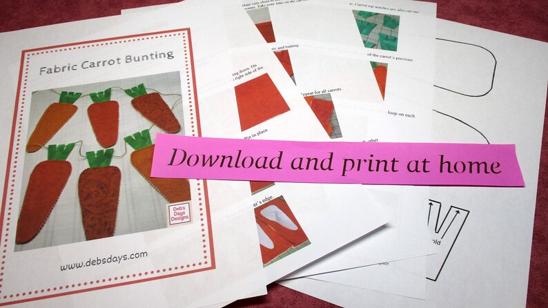 May include: A printable pattern for a fabric carrot bunting. The pattern includes instructions and templates for creating a string of carrots with green tops. The text on the pattern reads "Fabric Carrot Bunting" and "Download and print at home".