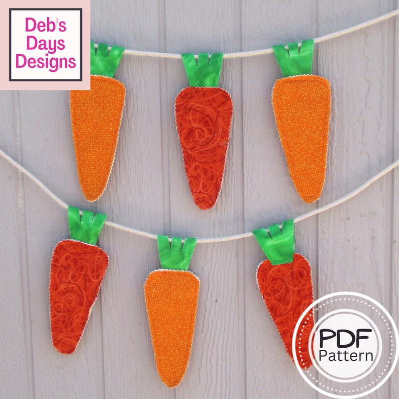 May include: A string of six carrot-shaped fabric decorations, each with a green top, hanging from a white string against a light gray wood background. The carrots are made of different fabrics, some with a swirl pattern and others with a speckled pattern. The text "PDF Pattern" is visible in a circle at the bottom right of the image.