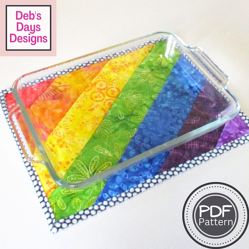 May include: Rainbow fabric hot pad with a glass baking dish on top. The hot pad is made of colorful fabric strips sewn together in a diagonal pattern. The fabric is a batik style with a floral design. The hot pad has a black and white polka dot border. The baking dish is clear glass with two handles. The text "PDF Pattern" is in a circle on the lower right corner of the image.