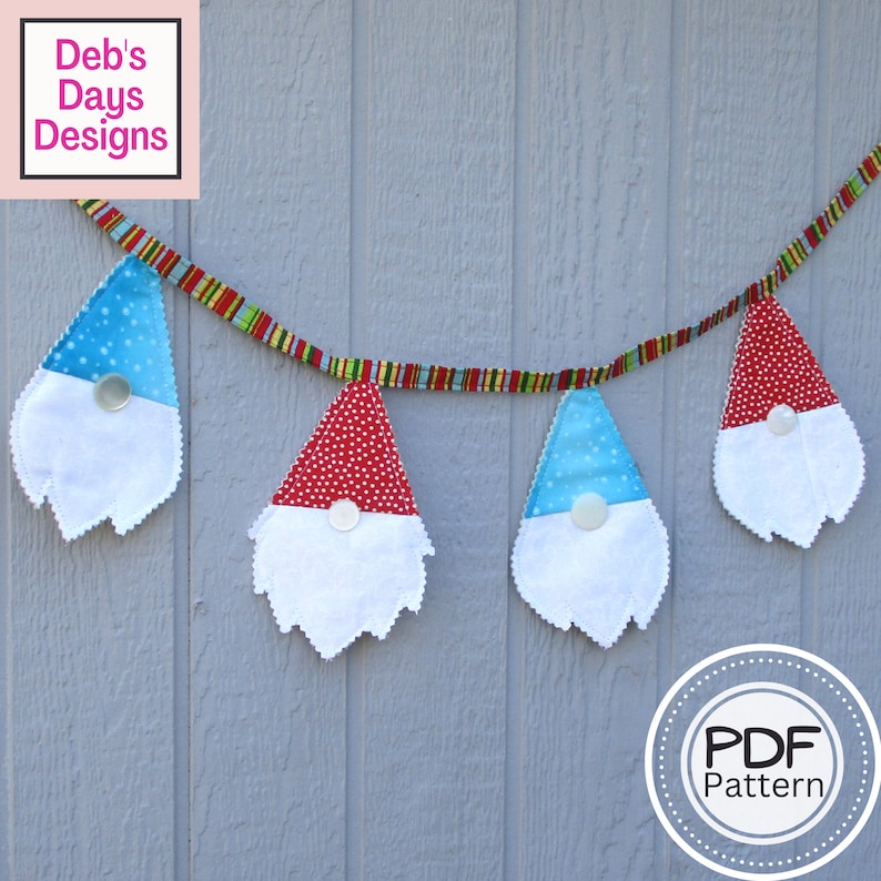 fabric gnomes with two fabrics and a button for the nose hanging off a fabric bunting